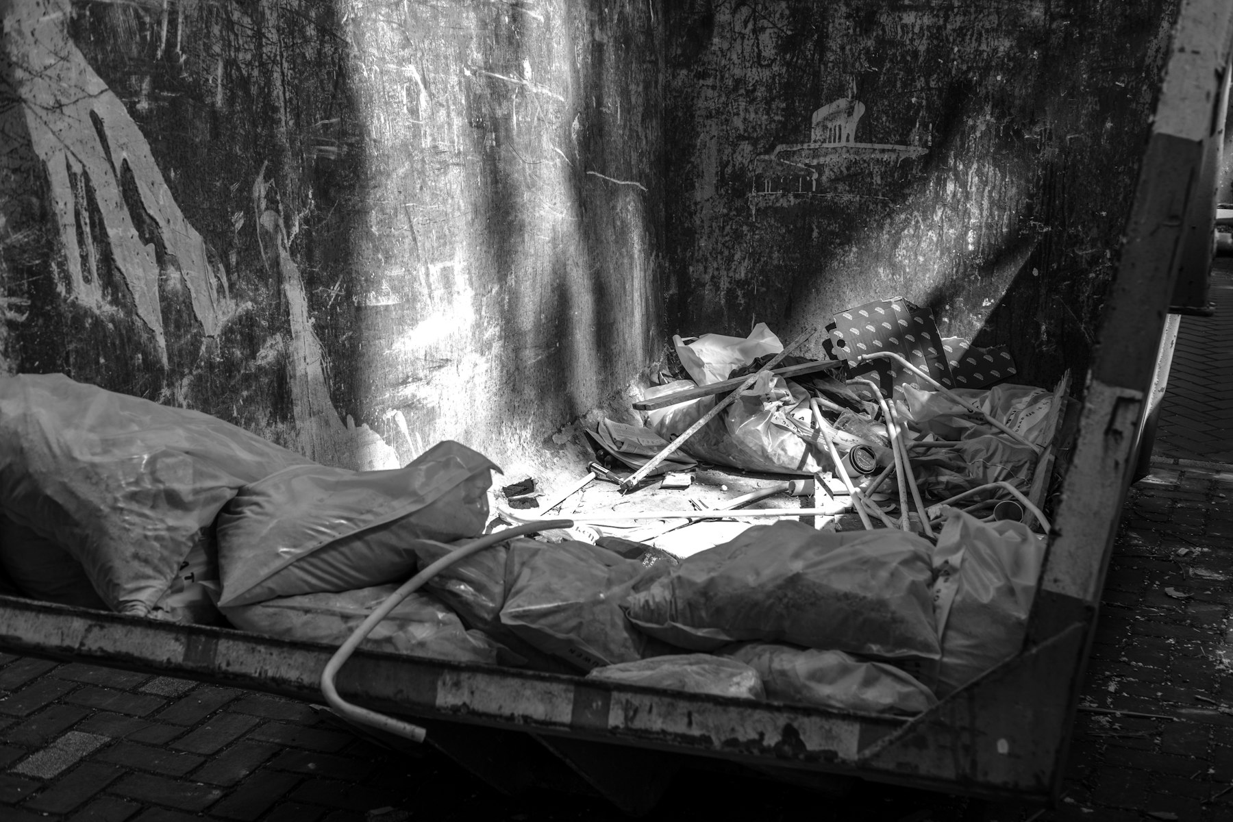 A roll-off container holding bags and mixed waste