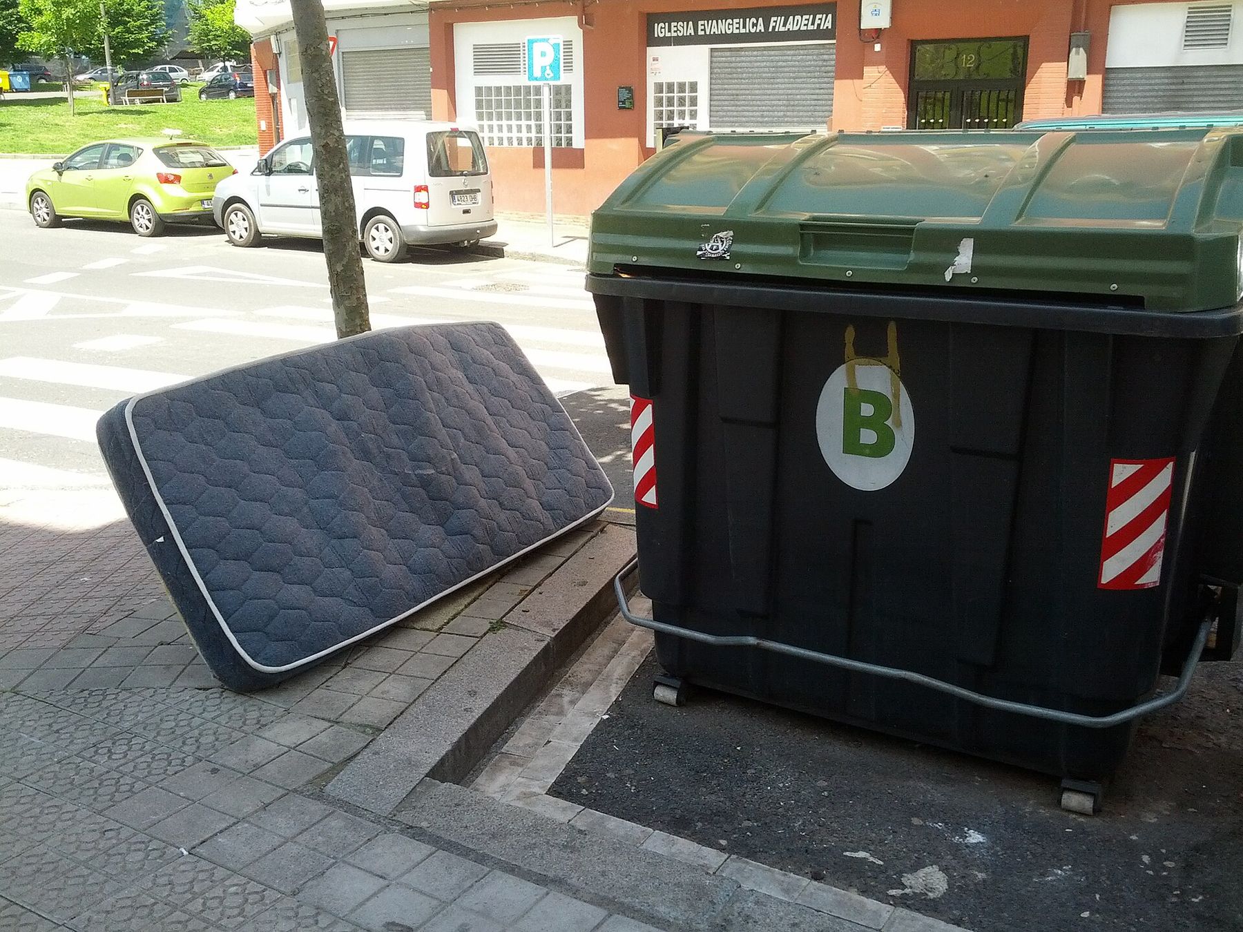 A mattress ready for pickup at the curb